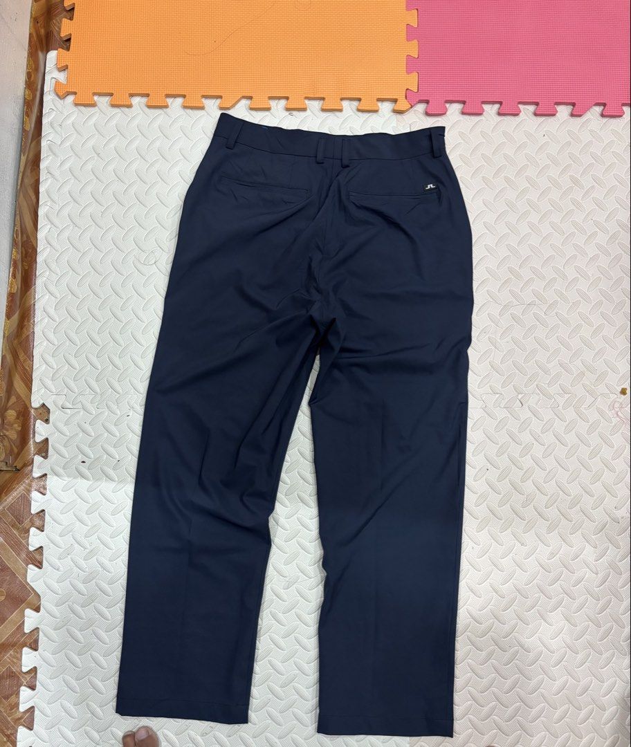 j.lindeberg W Key Micro Stretch Navy Pants Size 34 (Category: Trousers) located in Manila. Submitted by noribrahim.20 (Listing ID 1470694273, Image 2). Description: - Brand: J.Lindeberg (Model: W Key Micro Stretch) - Color: Navy blue - Size: 34 - Material: 100% polyester - Fit: Standard straight cut - Features: Dual back welt pockets, small logo tab, signature tricolor red, white, and blue interior waistband tape - Condition: Clean, minimal wear 