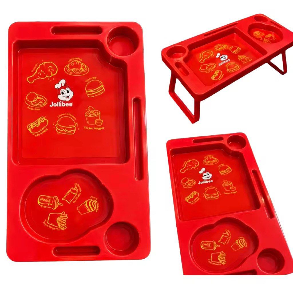 Jollibee Kids Foldable Lap Table Bed Tray Red (Category: Kids Tables & Chairs) located in Pasay City. Submitted by kimricasa (Listing ID 1470659149, Image 1). Description: - Authentic Jollibee red plastic lap desk - Sturdy, foldable metal legs for independent standing - Built-in cup holders and handy slot for pens or utensils - Fun graphics featuring classic menu favorites like Chickenjoy and Jolly Spaghetti - Easy to wipe clean and maintain.