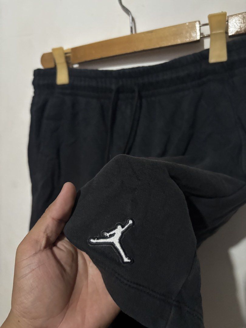 Jordan Black Shorts with Jumpman Logo (Category: Shorts) located in Subic. Submitted by thriftpoison (Listing ID 1470657785, Image 3). Description: - Authentic Jordan black shorts in a versatile solid color - Soft and cozy cotton fleece material for all-day comfort - Elastic waistband with adjustable black drawstring and branded metal aglets - Iconic white embroidered Jumpman logo on the left leg - Practical single back pocket on the right side -