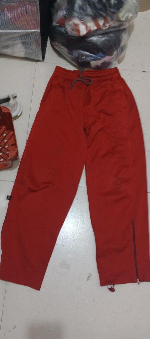 Jordan Dri-FIT Red Athletic Sweatpants Size S (Category: Joggers) located in San Juan City. Submitted by blueyohomeboy (Listing ID 1470688540, Image 1). Description: - Brand: Jordan - Color: Bright Red - Size: Small (S) - Material/Tech: Lightweight and breathable Dri-FIT technology - Features: Elastic waistband with adjustable drawstring, ankle zippers for easy on/off - Branding: Subtle Jordan Jumpman logo on left leg and small tag on side pocket