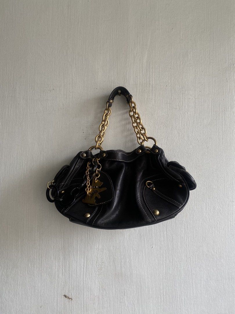 Juice Black Leather Shoulder Bag with Gold Chain (Category: Shoulder Bags) located in Manila. Submitted by anthony1723 (Listing ID 1470696959, Image 1). Description: - Brand: Juice - Material: Black leather with stylish contrast stitching - Straps: Chunky gold chain straps - Pockets: Exterior side pocket with gold-tone hardware and interior side pockets - Lining: Unique crown-patterned fabric interior - Extras: Playful dog charm and dark chain ha