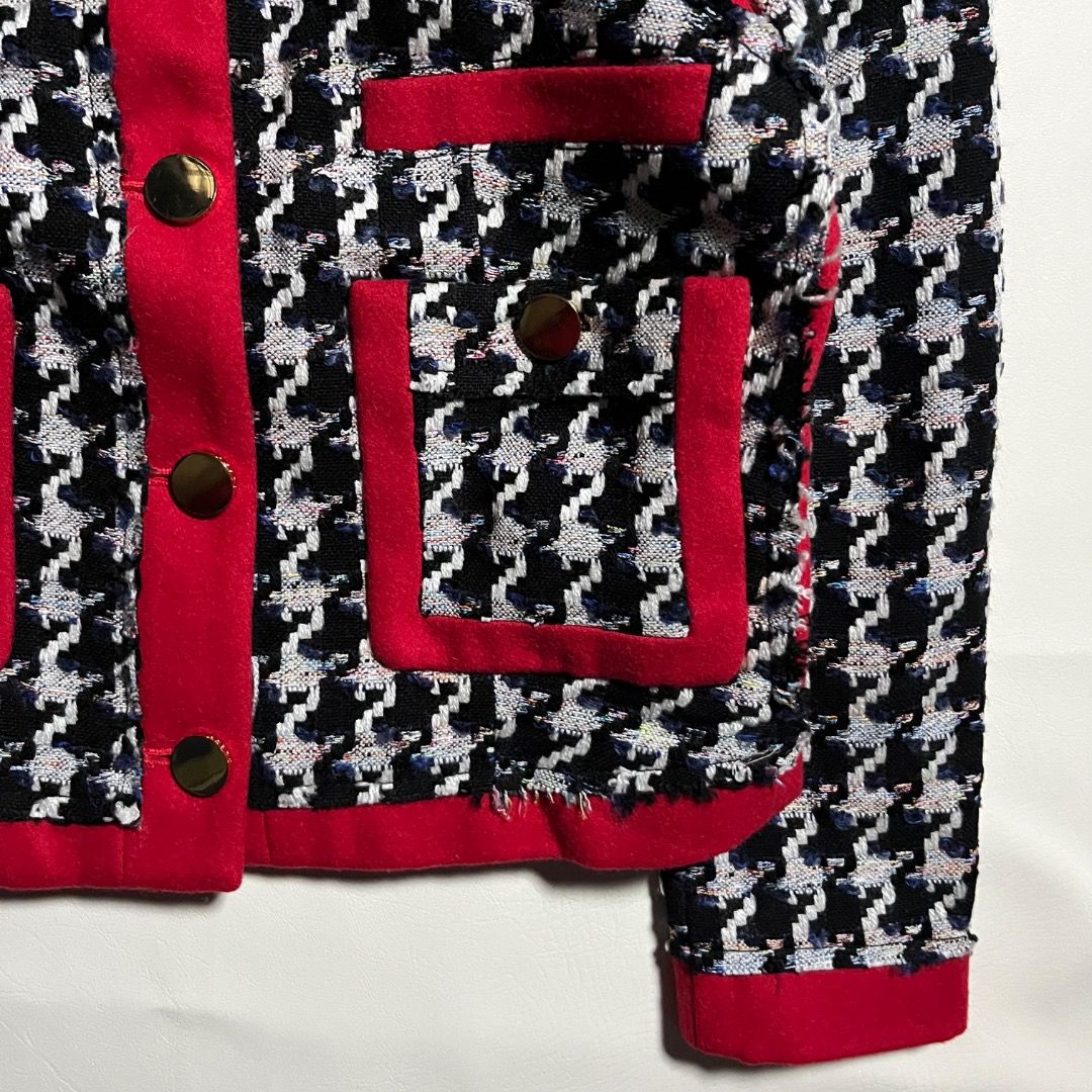 Juicy Couture Houndstooth Tweed Jacket Red Black (Category: Coats, Jackets and Outerwear) located in Caloocan City. Submitted by achilles_grails (Listing ID 1470728469, Image 3). Description: - Brand: Juicy Couture - Pattern/Color: Black & white houndstooth with vibrant red wool-blend trim - Material: 79% acrylic, 18% polyester, 3% wool; fully lined in black acetate - Details: Gold-toned front buttons, functional pocket details, and chain locker 
