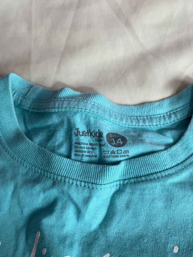 Just Kids Blue Tops Bundle Size 10 and 14 (Category: Babies & Kids Fashion) located in Iba. Submitted by wealtheallymari99 (Listing ID 1470714658, Image 3). Description: - Brand: Just Kids - Quantity: Bundle of 2 blue tops - Material: 100% Cotton, great for casual everyday wear - Item 1: Light blue ribbed tank top (Size 10) - Item 2: Turquoise tee with 'Believe in Yourself' graphic (Size 14) - Condition: Excellent/Pre-loved.