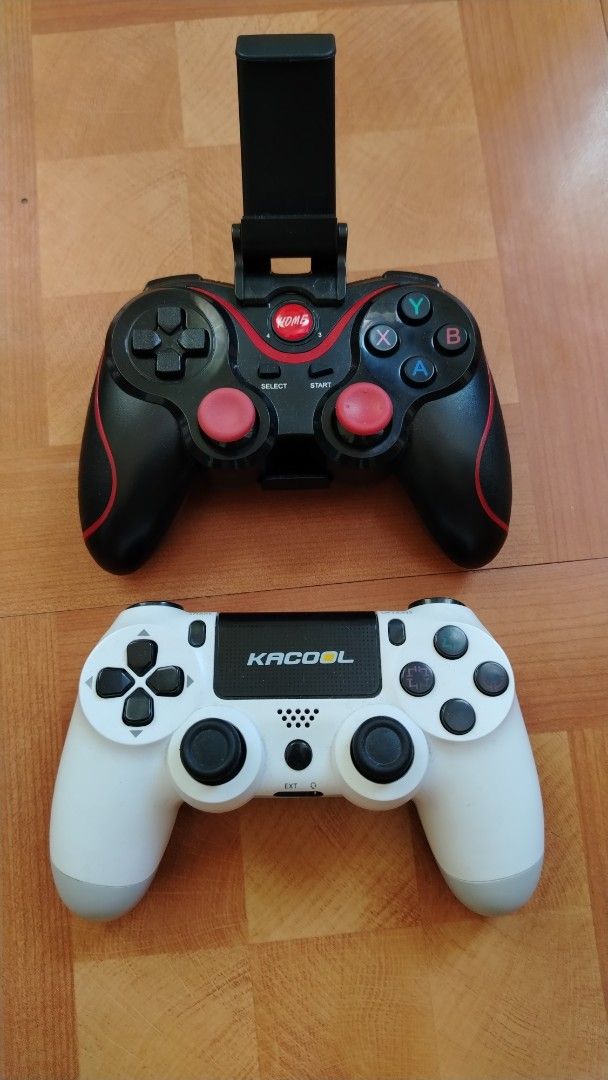 Kacool and X3 Wireless Game Controllers for Mobile and Console (Category: Controllers) located in Manila. Submitted by rosariomar80642 (Listing ID 1470574368, Image 1). Description: - Set of 2 wireless game controllers, cleaned and tested - Controller 1: Features a mobile phone mount and red thumbsticks for easy phone gaming - Controller 2: Black and white Kacool brand with a DualShock layout, dual analog sticks, and central touchpad - Great work