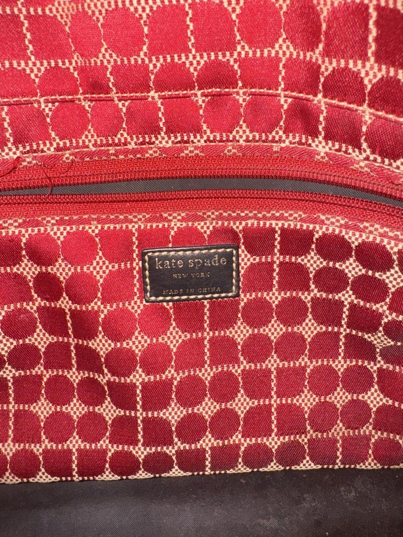 Kate Spade Tote Bag (Category: Tote Bags) located in Dumaguete. Submitted by dayvi143 (Listing ID 1470732789, Image 2). Description: - Brand: Kate Spade New York - Design: Red and beige pattern with dark brown leather double handles - Closure: Center strap with snap button - Interior: Spacious dark lining with 1 zipped pocket and slip pockets - Origin: Made in China - Perfect for work, travel, or everyday casual chic style - Price is still negoti