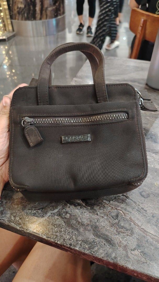 Kenneth Cole Reaction Brown Mini Handbag or sing bag (Category: Cross-body Bags) located in Manila. Submitted by purediamond888 (Listing ID 1470666542, Image 1). Description: - Brand: Reaction Kenneth Cole - Color: Brown - Size: Handy and compact, ideal for daily essentials, phone, and keys - Exterior: Dual top handles, front zippered pocket with metal logo plate - Closures: Zippered main compartment with inner magnetic snap closure - Interior: C