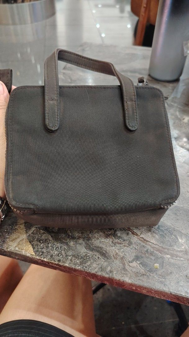 Kenneth Cole Reaction Brown Mini Handbag or sing bag (Category: Cross-body Bags) located in Manila. Submitted by purediamond888 (Listing ID 1470666542, Image 3). Description: - Brand: Reaction Kenneth Cole - Color: Brown - Size: Handy and compact, ideal for daily essentials, phone, and keys - Exterior: Dual top handles, front zippered pocket with metal logo plate - Closures: Zippered main compartment with inner magnetic snap closure - Interior: C