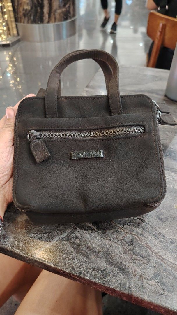 Kenneth Cole Reaction Brown Mini Handbag or sing bag (Category: Cross-body Bags) located in Manila. Submitted by purediamond888 (Listing ID 1470666542, Image 2). Description: - Brand: Reaction Kenneth Cole - Color: Brown - Size: Handy and compact, ideal for daily essentials, phone, and keys - Exterior: Dual top handles, front zippered pocket with metal logo plate - Closures: Zippered main compartment with inner magnetic snap closure - Interior: C