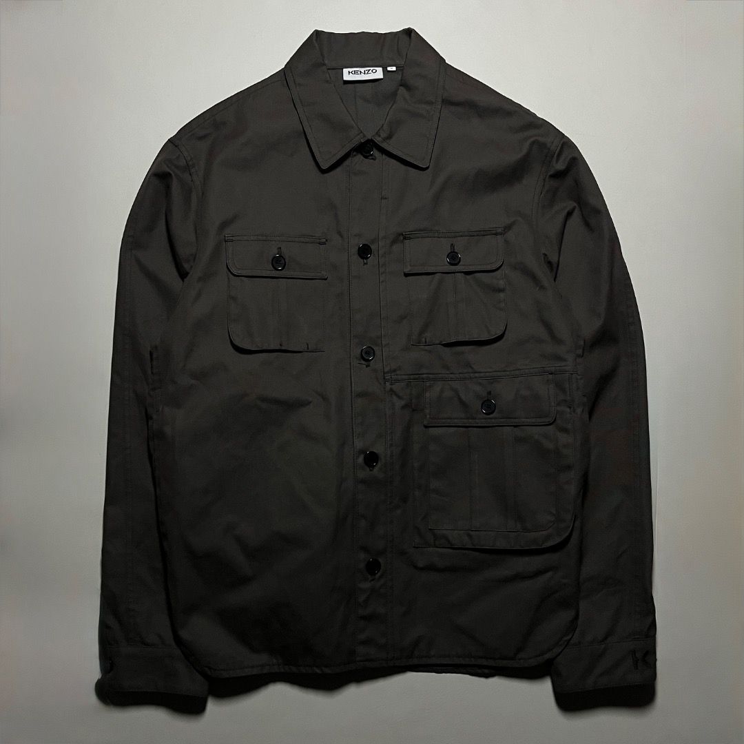 Kenzo Olive Green Tactical Jacket (Category: Tshirts & Polo Shirts ) located in Caloocan City. Submitted by achilles_grails (Listing ID 1470727612, Image 1). Description: - Brand/Model: Kenzo Utility Shirt - Color: Dark Grey - Size: Small (Regular Fit) - Material: 100% Cotton (Heavy twill feel) - Origin: Made in Bulgaria - Details: Multiple chest and lower front flap pockets, button closure, pointed collar - Branding: Subtle embroidered K logo ne