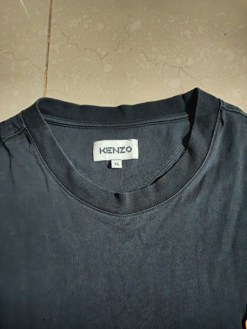 Kenzo Tiger Crest Embroidered Black Tee (Category: Tshirts & Polo Shirts ) located in Lapu Lapu. Submitted by rebuild.arkives (Listing ID 1470636628, Image 3). Description: Kenzo Tiger Crest Embroidered Black Tee ‎ ‎📏 Size Guide (Inches): ‎Length - 30 ‎Width - 22 ‎ ‎Color: 10/10 ‎Condition: 10/10 ‎Issue: None ‎ ‎📝 Heads up: ‎• This is a thrift item so please manage your expectations. ‎• Color may slightly differ due to lighting. ‎• Washed and r