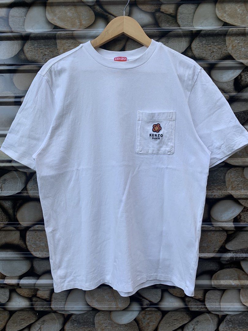 Kenzo x Nigo pocket tee. (Category: Shirts) located in Aloran. Submitted by chester78864 (Listing ID 1470668811, Image 1). Description: - Brand: Kenzo Paris - Color: White - Material: 100% Cotton - Size: Small (US S / CN 170/90A) - Fit: Regular fit, short sleeves, crew neck - Details: Left chest pocket with embroidered floral logo, red brand tag inside collar - Origin: Made in Portugal - Condition: Excellent, clean with no stains or damage.