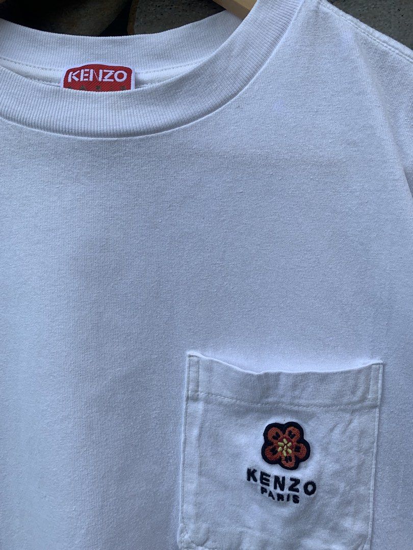 Kenzo x Nigo pocket tee. (Category: Shirts) located in Aloran. Submitted by chester78864 (Listing ID 1470668811, Image 2). Description: - Brand: Kenzo Paris - Color: White - Material: 100% Cotton - Size: Small (US S / CN 170/90A) - Fit: Regular fit, short sleeves, crew neck - Details: Left chest pocket with embroidered floral logo, red brand tag inside collar - Origin: Made in Portugal - Condition: Excellent, clean with no stains or damage.
