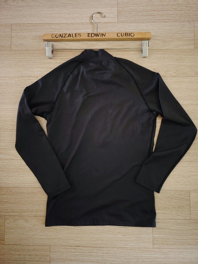 Kheizle Black Long Sleeve Compression Top Size XS (Category: Activewear) located in Nasipit. Submitted by edwingonzales498-69377 (Listing ID 1470613398, Image 2). Description: - Brand: Kheizle - Item: Black long sleeve compression top - Size: XS (Dimensions approx: 14" width x 21" length) - Details: Mock neck with white logo on collar and lower front, stretchable fabric, name label patch near bottom hem - Origin: Made in Korea - Condition/Use: Gr