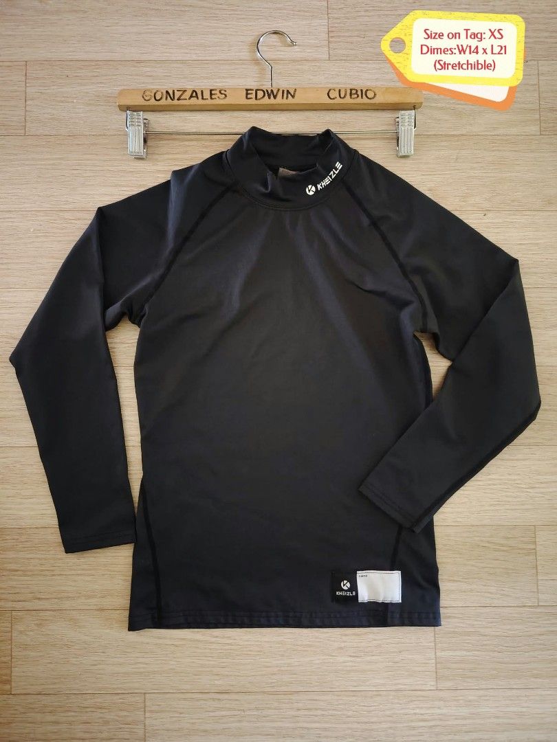 Kheizle Black Long Sleeve Compression Top Size XS (Category: Activewear) located in Nasipit. Submitted by edwingonzales498-69377 (Listing ID 1470613398, Image 1). Description: - Brand: Kheizle - Item: Black long sleeve compression top - Size: XS (Dimensions approx: 14" width x 21" length) - Details: Mock neck with white logo on collar and lower front, stretchable fabric, name label patch near bottom hem - Origin: Made in Korea - Condition/Use: Gr
