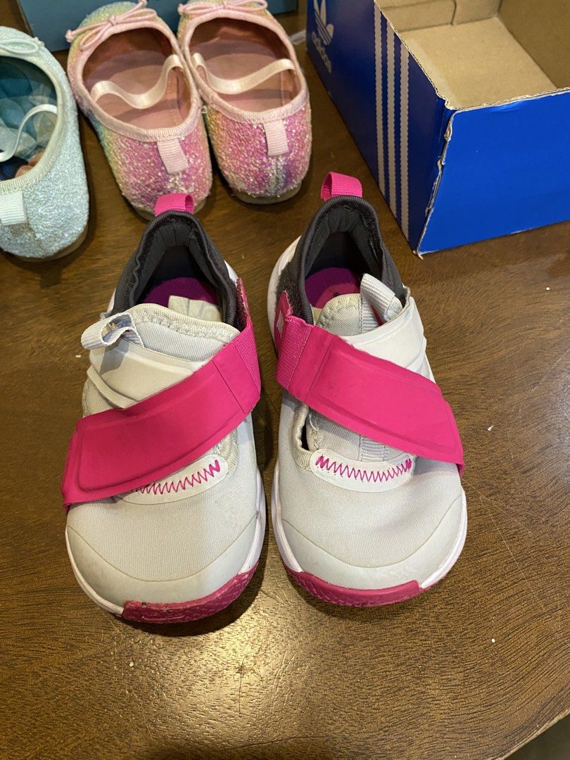 Kids athletic sneakers grey and pink (Category: Babies & Kids Fashion) located in Santa Rosa. Submitted by hoardqueensdeclutter (Listing ID 1470677148, Image 1). Description: - Color: Grey with vibrant pink accents - Closure: Easy hook-and-loop strap for quick wear - Design: Stylish pink cross-straps and zigzag stitching on the upper - Sole: White and pink rubber outsole with textured grip patterns - Condition: Excellent pre-loved condition with 