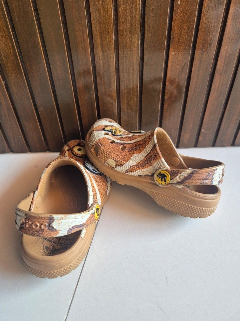 Kids Crocs Jurassic World (Category: Babies & Kids Fashion) located in Cainta. Submitted by mintandcinnamon (Listing ID 1470559838, Image 2). Description: Jurassic World kids clogs by Crocs. Brown dinosaur scale pattern with attached themed charms on the upper. Adjustable heel strap with dinosaur logo button. Size C12 stamped on the soles. Clean treads with minimal wear on the bottom. Ready for a young dinosaur fan to wear..