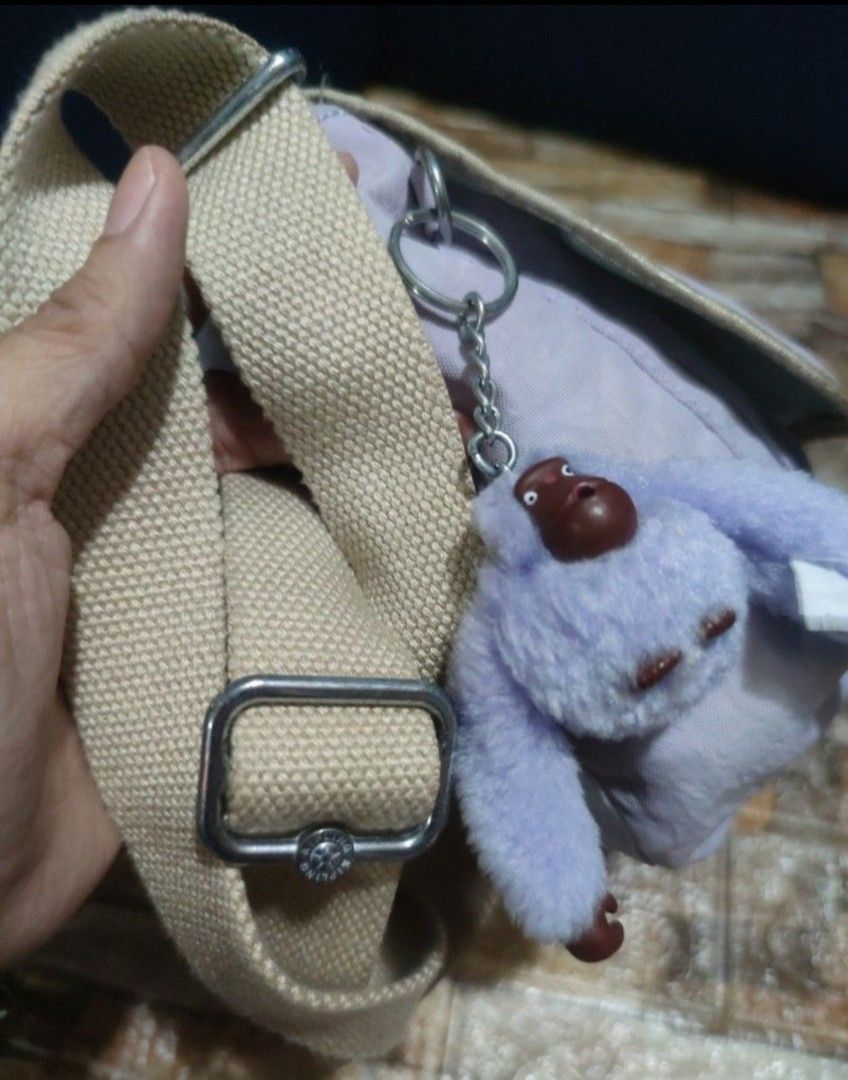 Kipling Crossbody Bag Light Purple with Monkey Keychain (Category: Cross-body Bags) located in Villasis. Submitted by jinkyreyann (Listing ID 1470617337, Image 3). Description: - Brand: Kipling Crossbody Bag - Color: Light purple with beige adjustable strap and mint green interior lining - Exterior: Front flap closure and convenient back slip pocket - Interior: Spacious main compartment with an extra zipper pocket - Inclusions: Comes with the ico
