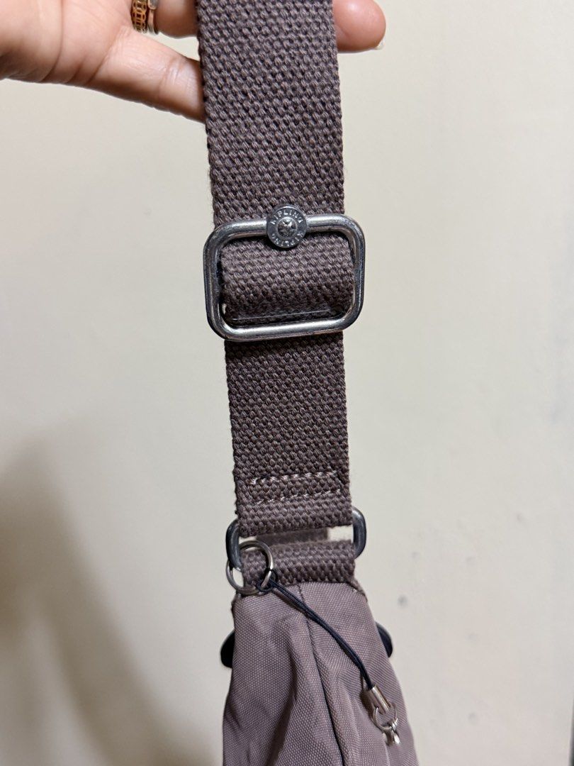 Kipling K13335-757 Crossbody Bag Brown (Category: Cross-body Bags) located in Paete. Submitted by skydruemadison (Listing ID 1470682735, Image 3). Description: - Brand: Kipling Crossbody Bag - Model Code: K13335-757 - Color: Brown in signature crinkle nylon - Hardware: Silver-tone with round Kipling logo badge - Compartments: Multiple zipped front compartments for easy organization - Strap: Adjustable canvas strap for comfortable wear - Interior: