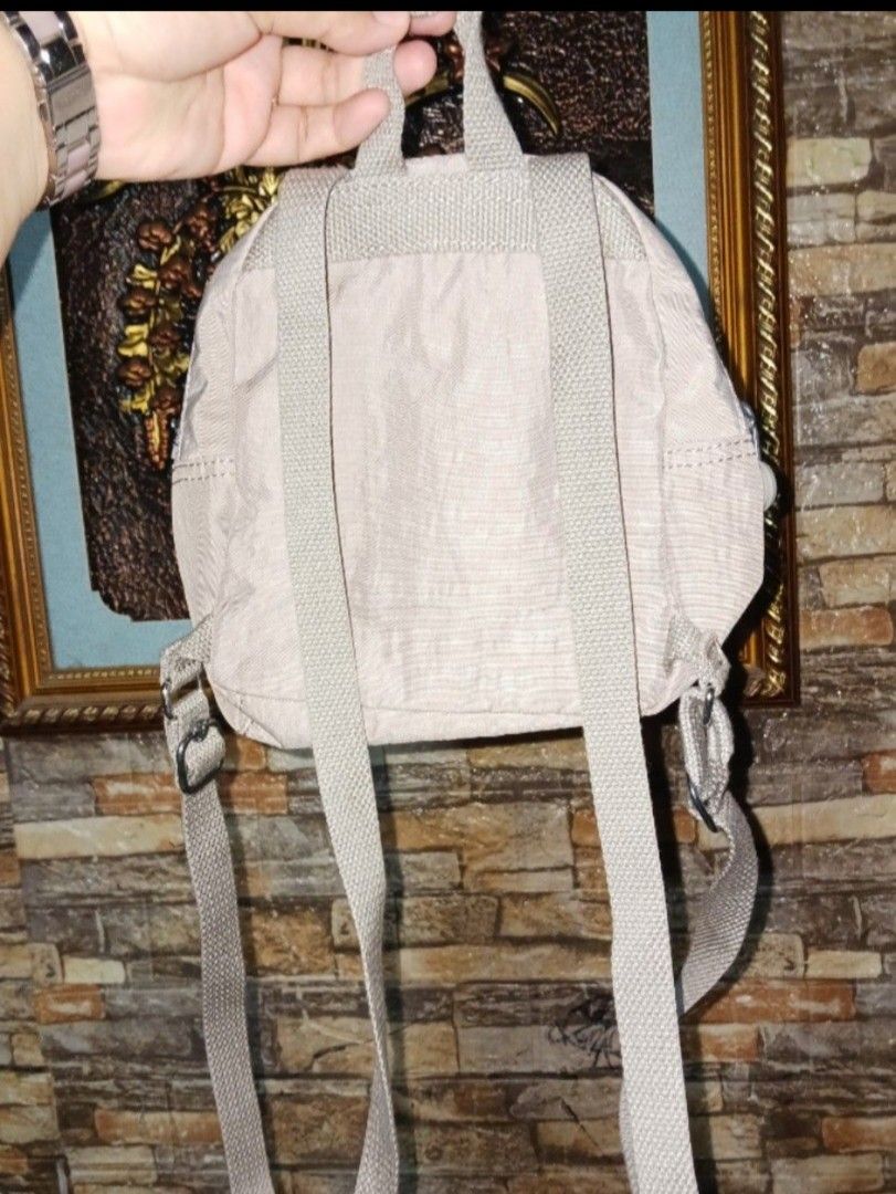 Kipling Mini Backpack Beige KPKI13860GF1 (Category: Backpacks) located in Villasis. Submitted by jinkyreyann (Listing ID 1470739609, Image 2). Description: - Authentic Kipling backpack in classic beige - Compact and lightweight design made from durable nylon crinkle fabric - Features the signature furry monkey keychain - Main compartment with inner slip pocket for organization - Handy front zipped pocket for quick-access items - Adjustable woven 