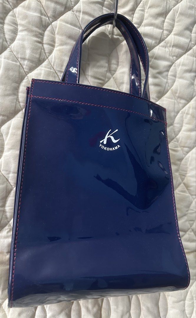 Kitamura Patent Leather HandBag from Japan (Category: Tote Bags) located in Santa Rosa. Submitted by esplanamur03635 (Listing ID 1470690914, Image 2). Description: Authentic Kitamura 2 Yokohama navy patent leather handbag. Features a glossy finish, red stitching, and white logo details. Includes a fabric lining and inner zipper pocket. Compact and stylish for everyday use. mop: gcash/paymaya/bank transfee.