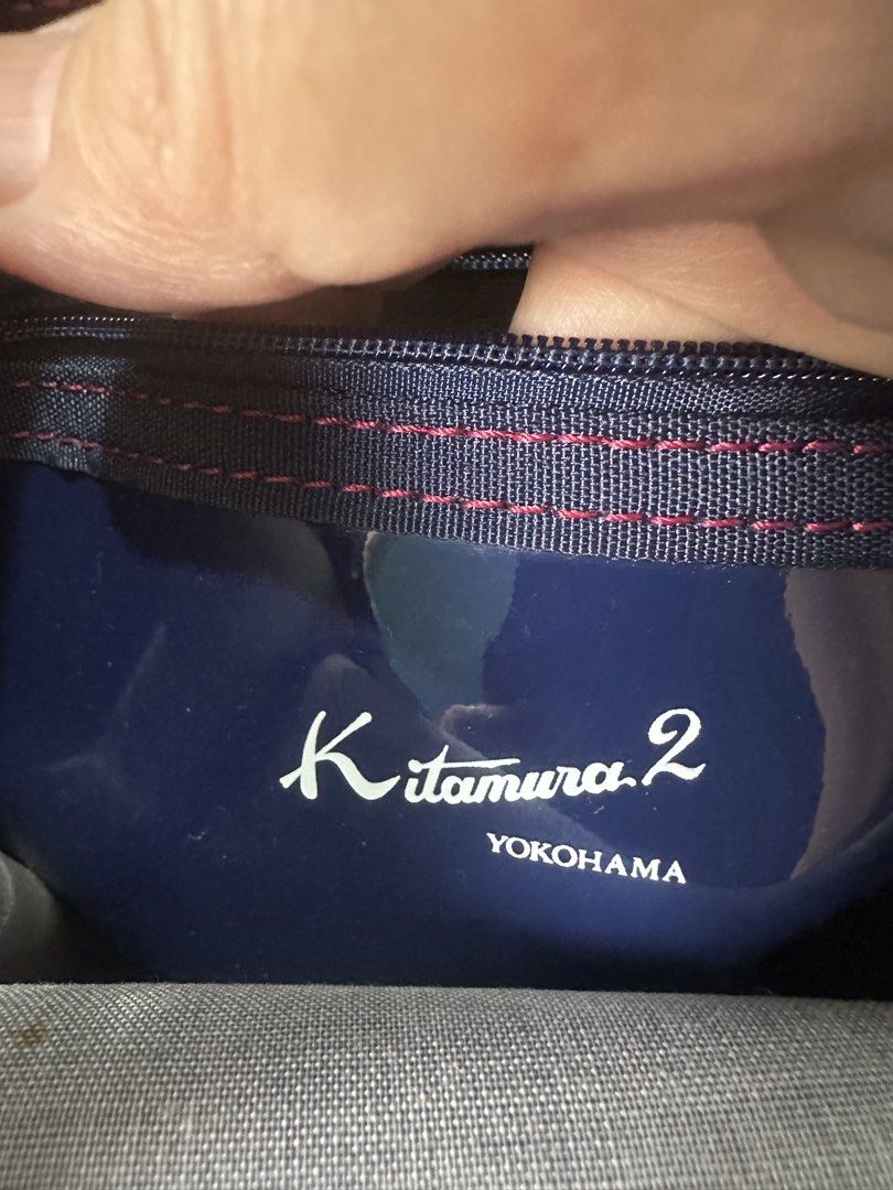 Kitamura Patent Leather HandBag from Japan (Category: Tote Bags) located in Santa Rosa. Submitted by esplanamur03635 (Listing ID 1470690914, Image 3). Description: Authentic Kitamura 2 Yokohama navy patent leather handbag. Features a glossy finish, red stitching, and white logo details. Includes a fabric lining and inner zipper pocket. Compact and stylish for everyday use. mop: gcash/paymaya/bank transfee.