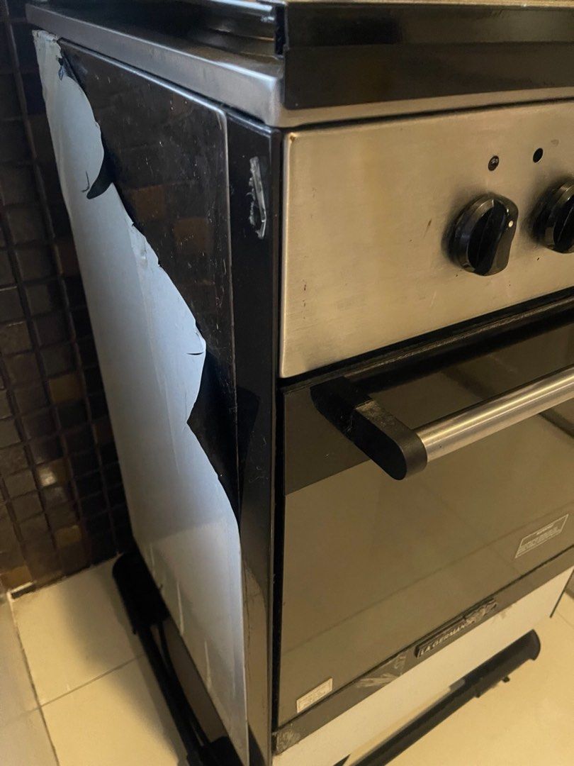 La Germania electric range (Category: Cookers) located in Manila. Submitted by roberto.enriquez (Listing ID 1470730168, Image 2). Description: - Brand: La Germania (trusted quality kitchen appliance) - Type: Gas stove and oven combo unit - Control Panel: Stainless steel with 4 black rotary knobs and push buttons - Oven: Sleek black glass door with metal handle and La Germania logo - Storage: Standard white bottom compartment drawer - Mobility: Si