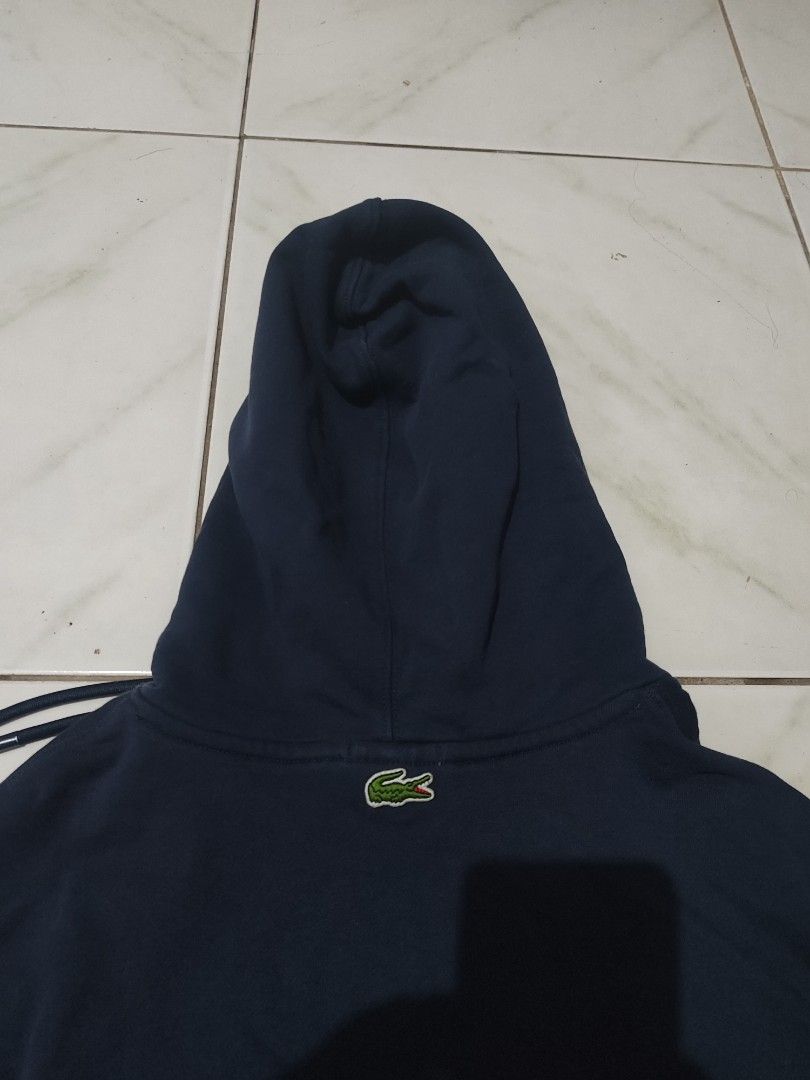 Lacoste 3D logo Hoodie (Category: Coats, Jackets and Outerwear) located in Tuguegarao City. Submitted by johnpetera0818 (Listing ID 1470719114, Image 3). Description: - Brand: Lacoste - Color: Dark Navy Blue - Size: XL (Loose Fit / Unisex) - Material: 100% Cotton (Made in China) - Features: Classic embroidered crocodile logo on chest, extra small logo on back collar - Details: Adjustable drawstring hood with metal aglets & front kangaroo pocket -