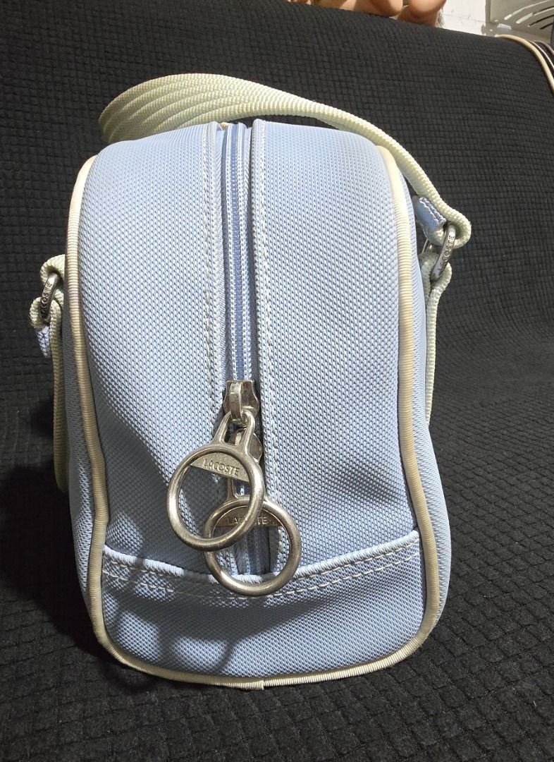 Lacoste Light Blue Barrel Handbag - Negotiable!!! (Category: Shoulder Bags) located in Manila. Submitted by axelyuna.27 (Listing ID 1470580770, Image 3). Description: Authentic light blue Lacoste barrel bag with cream handles and piping. Features dual zippers, green and white striped lining, an internal clasp strap, and the iconic embroidered crocodile logo. Compact and stylish for everyday use!.