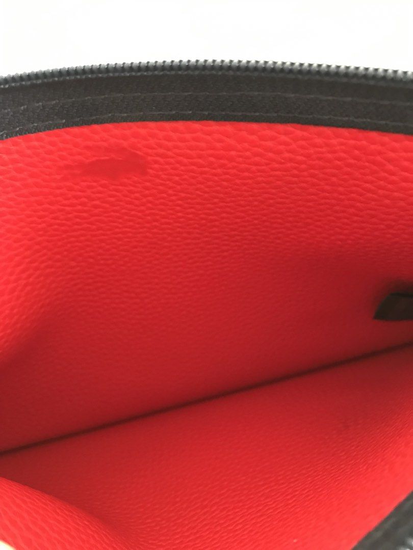 Lacoste Navy Blue Zip Pouch with Red Interior (Category: Purses & Pouches) located in Cainta. Submitted by ukaymama (Listing ID 1470608030, Image 3). Description: - Brand: Lacoste - Color: Navy blue exterior with a bright red inner lining - Material: Textured exterior and pebbled leather interior - Design: Features a debossed crocodile logo and smooth zipper closure with a matching dark pull tab - Condition: Clean interior and exterior with minim