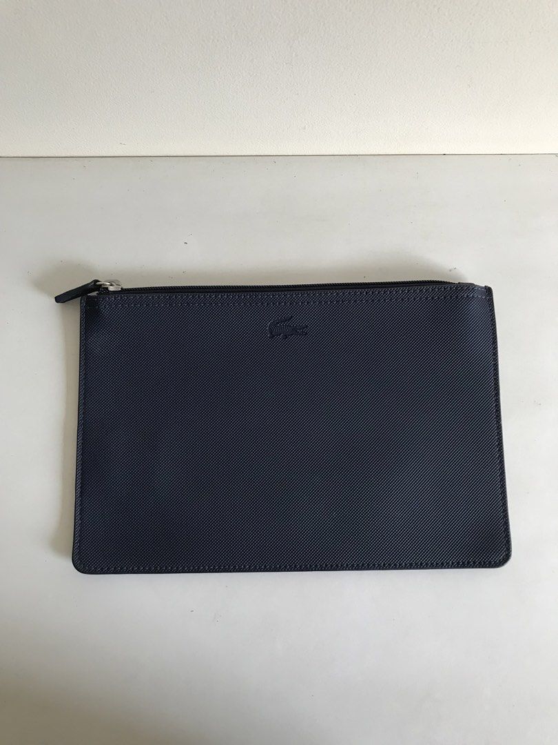 Lacoste Navy Blue Zip Pouch with Red Interior (Category: Purses & Pouches) located in Cainta. Submitted by ukaymama (Listing ID 1470608030, Image 2). Description: - Brand: Lacoste - Color: Navy blue exterior with a bright red inner lining - Material: Textured exterior and pebbled leather interior - Design: Features a debossed crocodile logo and smooth zipper closure with a matching dark pull tab - Condition: Clean interior and exterior with minim
