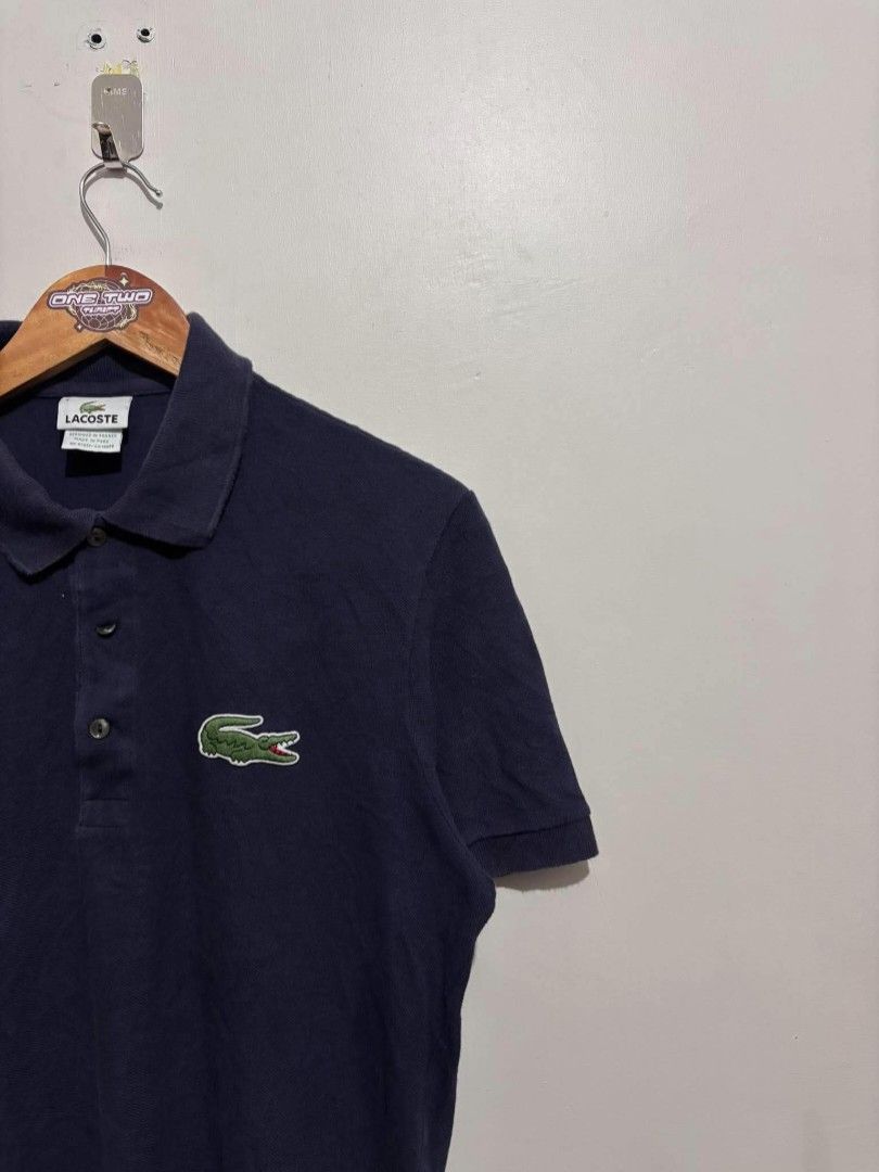 Lacoste Polo Shirt (Category: Tshirts & Polo Shirts ) located in Bauan. Submitted by onetwothrift2 (Listing ID 1470675957, Image 2). Description: Lacoste Polo Shirt Size: Med - Larde Dimes: L26 W21 Color rate: 9/10 Good condition No issue.