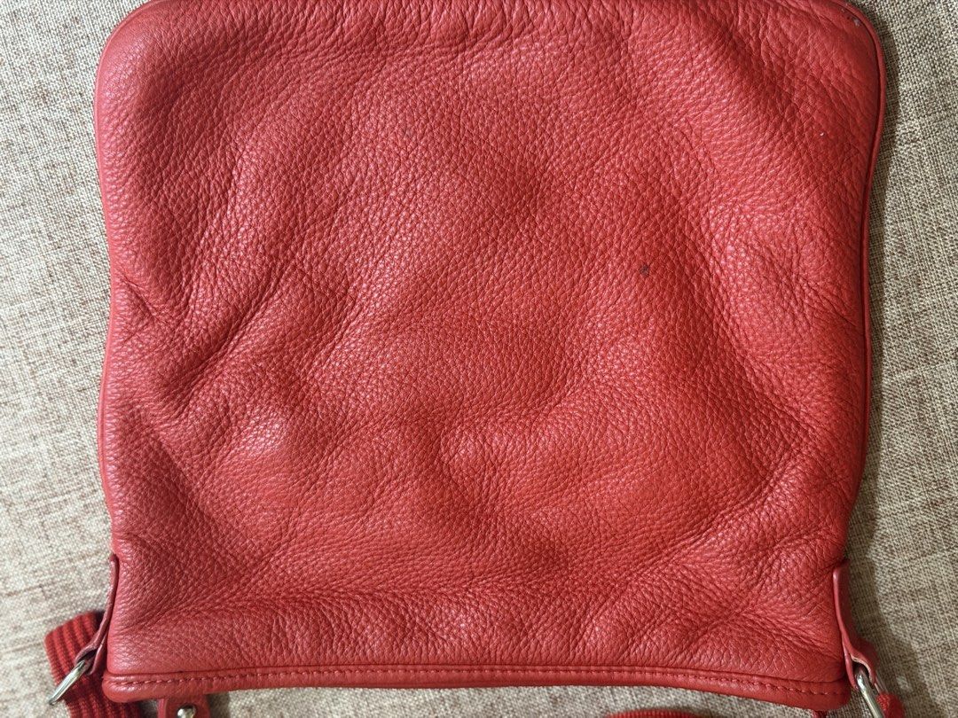 Lacoste Red Leather Crossbody Bag (Category: Cross-body Bags) located in Taguig. Submitted by markitopinas (Listing ID 1470618792, Image 3). Description: - Brand: Lacoste - Style: Red leather crossbody bag with debossed crocodile logo - Size: Medium (fits daily essentials) - Strap: Adjustable red canvas strap - Closure & Interior: Zip top closure, dark fabric lining, interior zippered pocket, and leather brand tag - Condition: Minor creasing on t
