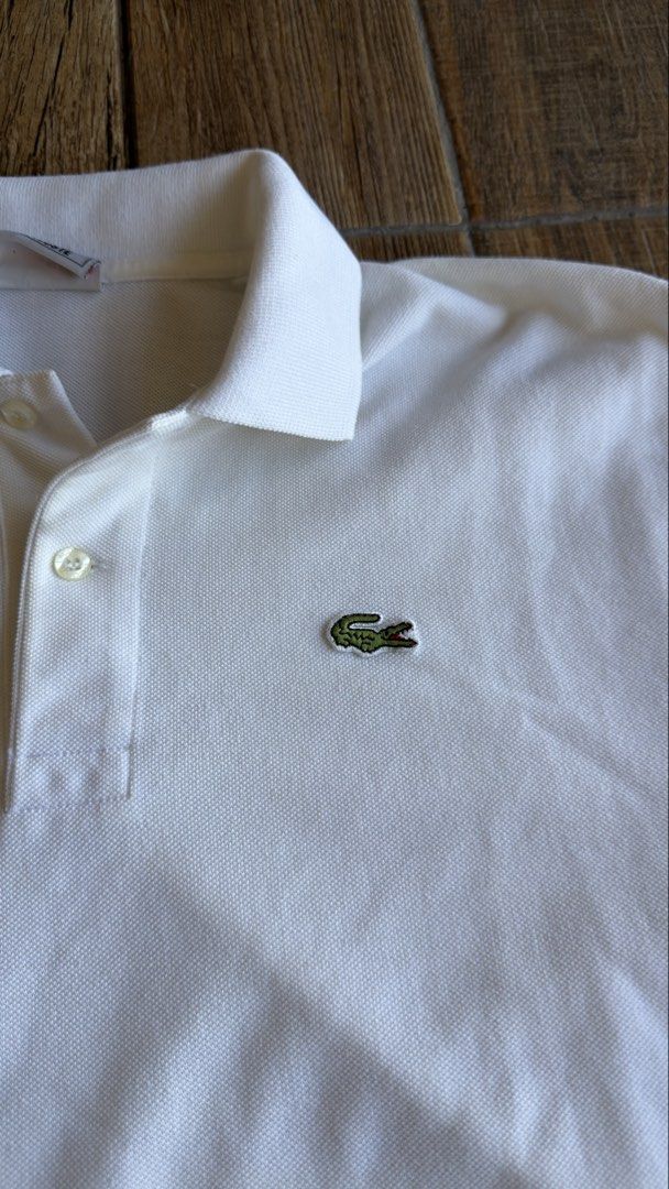LACOSTE WHITE POLO (Category: Shirts) located in Manila. Submitted by urban.vintage (Listing ID 1470589137, Image 2). Description: ISSUE: NONE (NEED WASH) MOP :GCASH (NO COD) SHIP VIA: LALAMOVE & J&T LOCATION: PASIG CITY LENGTH: 28 WIDTH : 21.