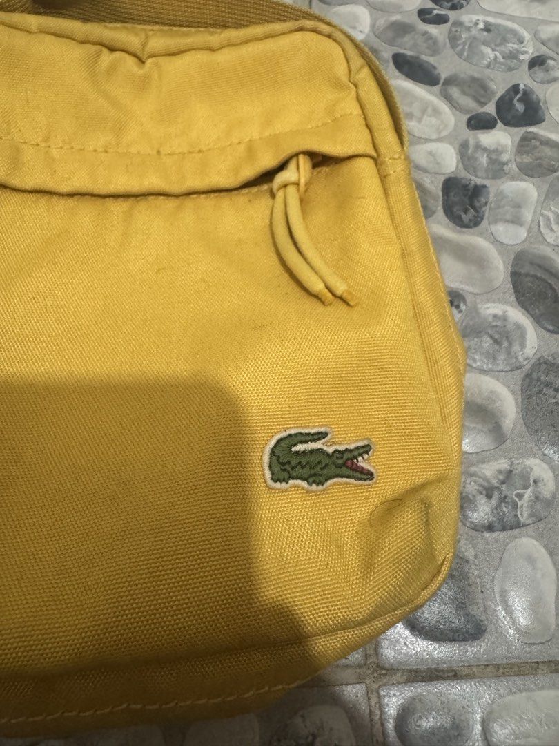 Lacoste Yellow Crossbody Bag (Category: Sling Bags) located in Manila. Submitted by misfits.ph (Listing ID 1470658461, Image 2). Description: Lacoste yellow sling bag Excellent condi see pics ₱1050 only Manila area Jnt lalamove.