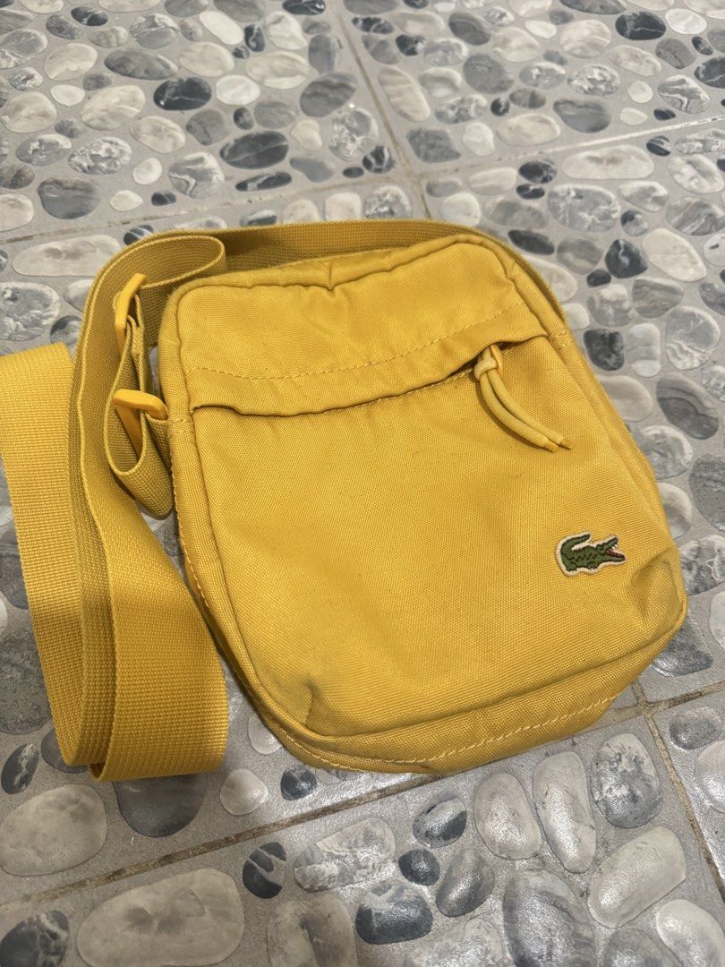Lacoste Yellow Crossbody Bag (Category: Sling Bags) located in Manila. Submitted by misfits.ph (Listing ID 1470658461, Image 1). Description: Lacoste yellow sling bag Excellent condi see pics ₱1050 only Manila area Jnt lalamove.