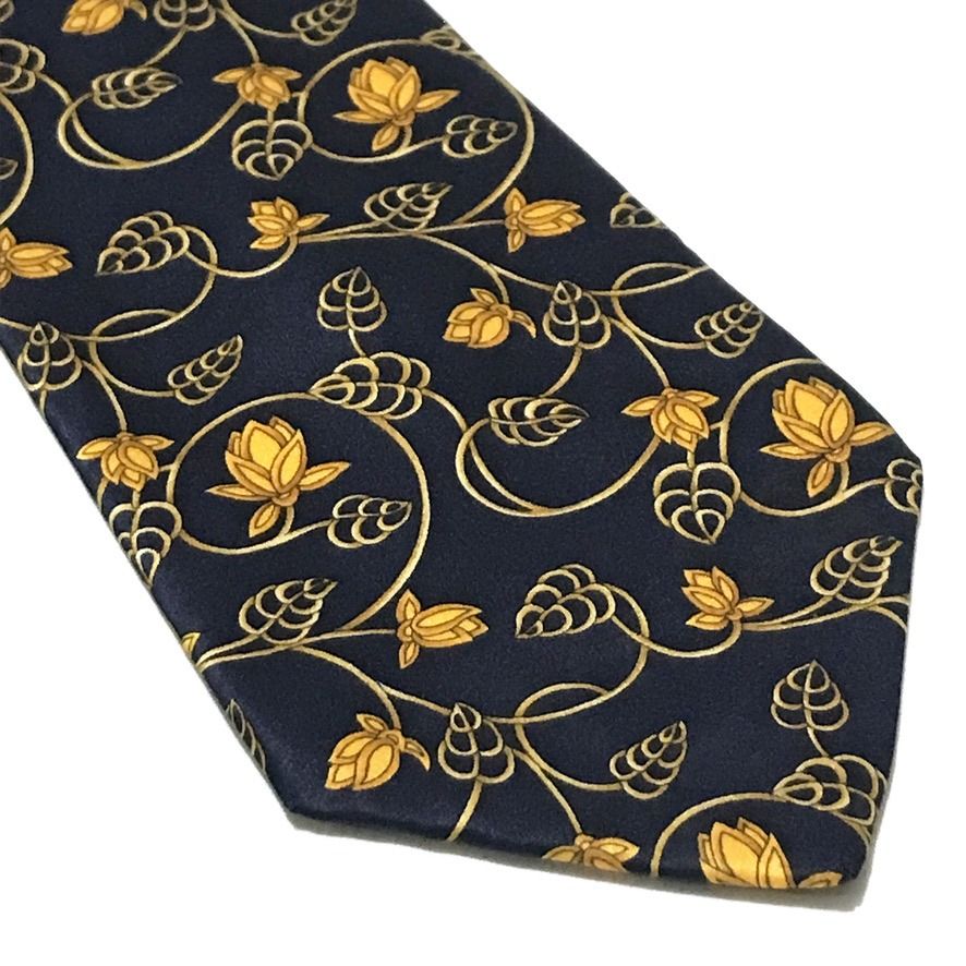 Lanvin Deep Navy Floral Neck Tie (Category: Ties) located in Taguig. Submitted by retrogaze (Listing ID 1470713190, Image 2). Description: This luxury 100% silk necktie by Lanvin features a smooth, deep navy blue satin base adorned with an intricate Art Nouveau-inspired botanical print. The design showcases sinuous golden vines, delicate leaf tendrils, and stylized lotus blossoms in rich golden-yellow hues flowing gracefully across the length of 