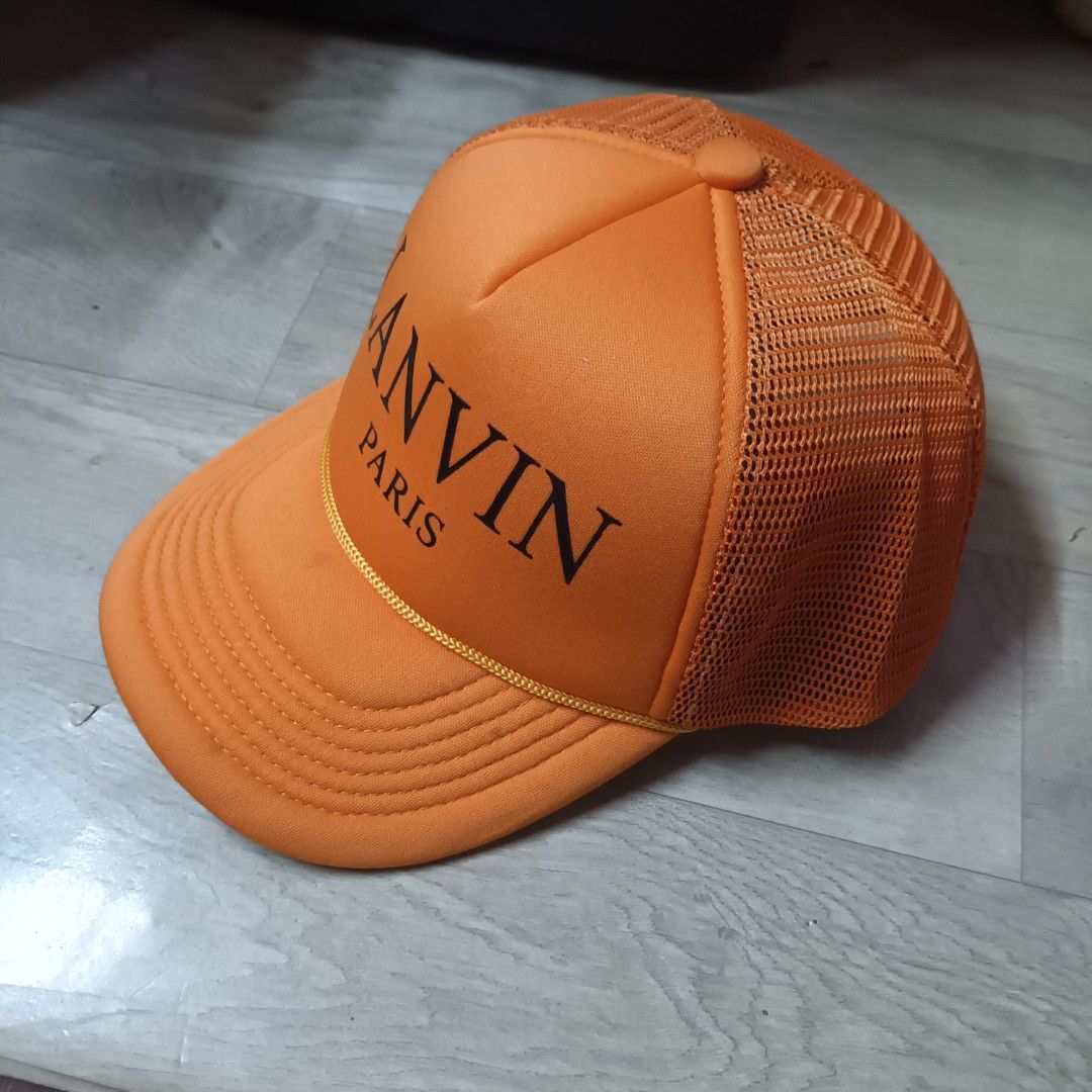 Lanvin Paris Orange Trucker Hat (Category: Caps & Hats) located in Manila. Submitted by itsnik444 (Listing ID 1470642986, Image 2). Description: - Brand: Lanvin Paris - Color: Vibrant orange with bold black lettering - Material: Foam front panel and breathable mesh back - Fit: Adjustable snapback closure - Details: Branded interior taping and classic woven label inside - Condition: Brand new / Excellent (ready to wear) - Mode of Payment: GCash, B