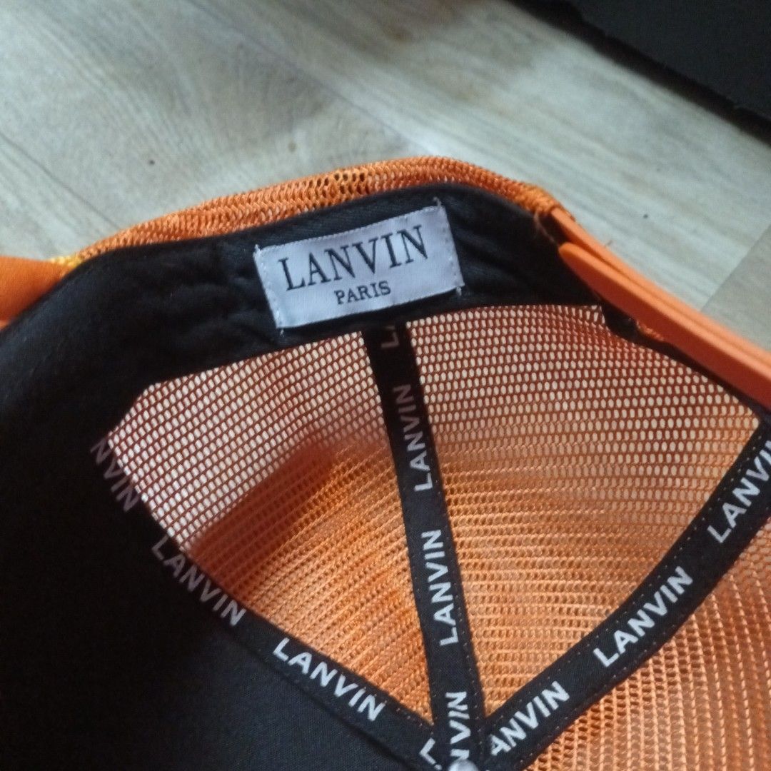 Lanvin Paris Orange Trucker Hat (Category: Caps & Hats) located in Manila. Submitted by itsnik444 (Listing ID 1470642986, Image 3). Description: - Brand: Lanvin Paris - Color: Vibrant orange with bold black lettering - Material: Foam front panel and breathable mesh back - Fit: Adjustable snapback closure - Details: Branded interior taping and classic woven label inside - Condition: Brand new / Excellent (ready to wear) - Mode of Payment: GCash, B