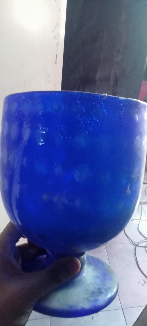 Large Blue Glass Goblet Chalice (Category: Dinnerware & Cutlery) located in Paranaque City. Submitted by dimaguilaa24827 (Listing ID 1470656529, Image 1). Description: - Type: Large blue glass goblet - Design: Heavy bulbous bowl with all-over textured dot patterns - Base & Stem: Thick stem with a wide, mottled blue and white circular base - Condition: Clean interior and solid glass construction throughout - Use: Ideal as a stunning decorative acc