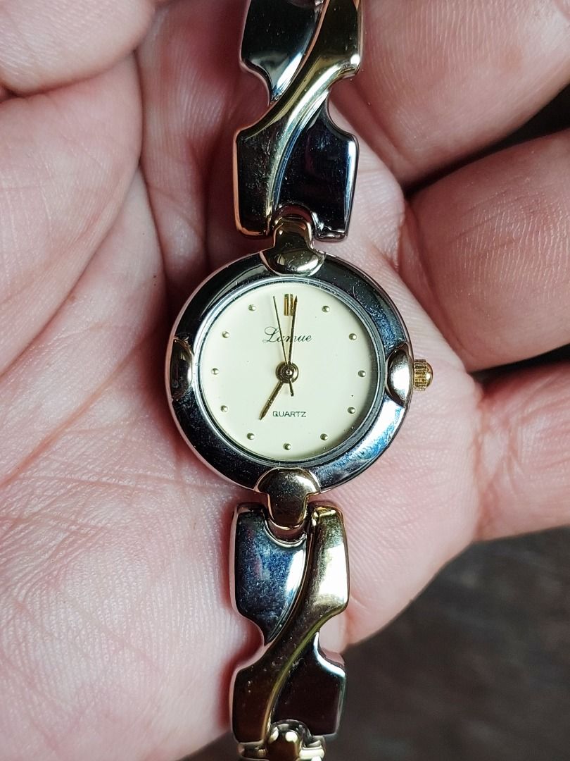 Larue Quartz Two-Tone Watch JAXIS 20/520-W (Category: Women's Watches) located in Batangas. Submitted by vintageanddainty (Listing ID 1470586002, Image 2). Description: - Brand/Model: Larue Quartz Watch (JAXIS 20/520-W) - Design: Two-tone silver and gold metal bezel with stainless steel back - Dial: Classic cream round dial with elegant gold hands and markers - Bracelet: Unique patterned link bracelet combining silver and gold tones for a versati