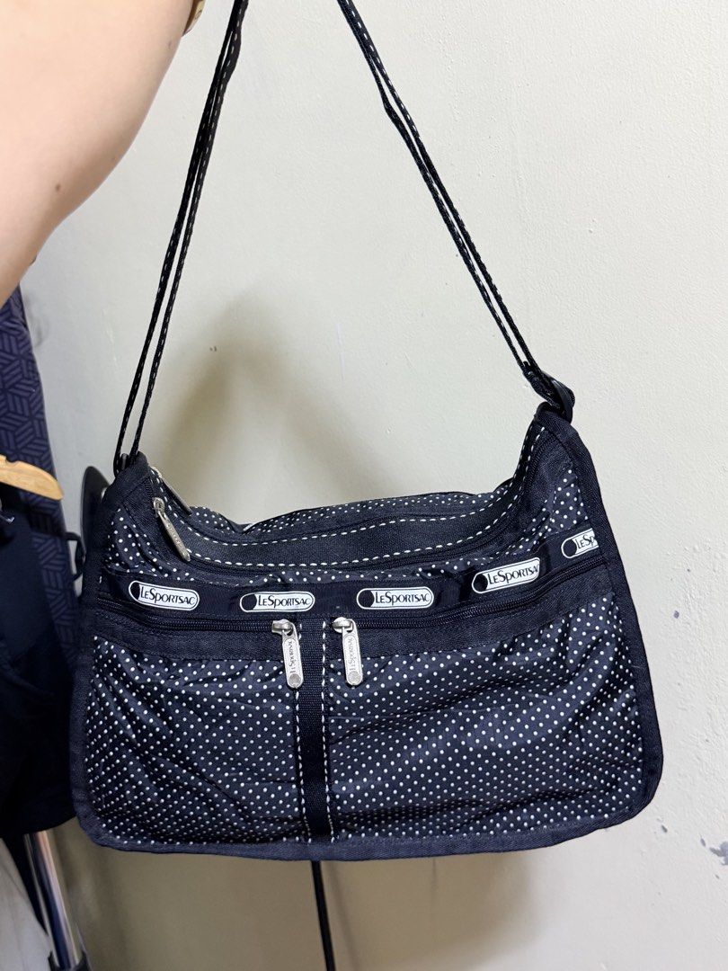 LeSportsac Black Polka Dot Multi-Zip Shoulder Bag (Category: Shoulder Bags) located in Paete. Submitted by skydruemadison (Listing ID 1470680458, Image 3). Description: - Brand: LeSportsac - Color/Design: Classic black with white polka dots - Material: Lightweight, foldable nylon - Compartments: Multiple exterior zipped pockets with signature logo ribbon pull tabs - Straps: Comfortable double shoulder straps - Size: Roomy interior, perfect for ev