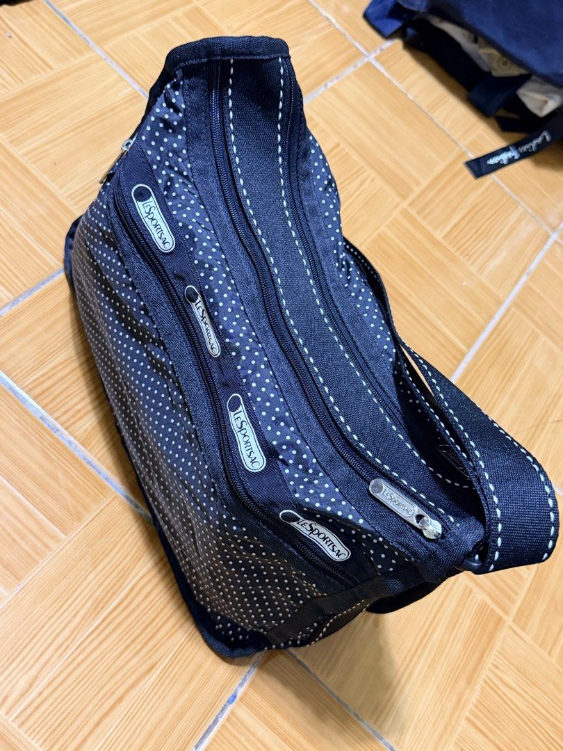 LeSportsac Black Polka Dot Multi-Zip Shoulder Bag (Category: Shoulder Bags) located in Paete. Submitted by skydruemadison (Listing ID 1470680458, Image 2). Description: - Brand: LeSportsac - Color/Design: Classic black with white polka dots - Material: Lightweight, foldable nylon - Compartments: Multiple exterior zipped pockets with signature logo ribbon pull tabs - Straps: Comfortable double shoulder straps - Size: Roomy interior, perfect for ev