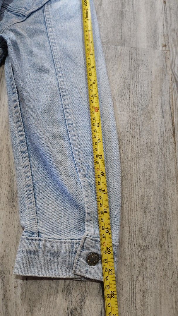 Levi Strauss & Co. Vintage Light Wash Denim Jacket (Category: Coats, Jackets and Outerwear) located in Quezon City. Submitted by truedeer_cda94c (Listing ID 1470607485, Image 3). Description: - Brand: Levi Strauss - Style: Light wash denim jacket with stand collar and retro faded finish - Details: Front utility pockets and metal button closures on front and cuffs - Fit/Back: Comfortable ribbed elastic hem at the back.