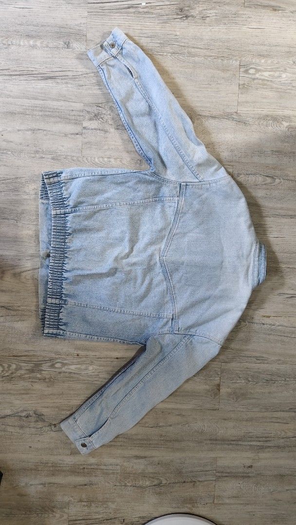 Levi Strauss & Co. Vintage Light Wash Denim Jacket (Category: Coats, Jackets and Outerwear) located in Quezon City. Submitted by truedeer_cda94c (Listing ID 1470607485, Image 2). Description: - Brand: Levi Strauss - Style: Light wash denim jacket with stand collar and retro faded finish - Details: Front utility pockets and metal button closures on front and cuffs - Fit/Back: Comfortable ribbed elastic hem at the back.