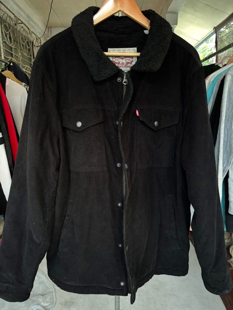 Levi's Black Corduroy Sherpa Jacket (Category: Coats, Jackets and Outerwear) located in Mati. Submitted by abu_razmey (Listing ID 1470728427, Image 1). Description: - Brand: Levi's - Material: Black corduroy with thick sherpa lining and collar - Closure: Front metal buttons plus zipper - Pockets: Two buttoned chest flap pockets and lower side pockets - Details: Iconic red Levi's tab and branded metal hardware - Fit/Use: Warm winter layer, stylish