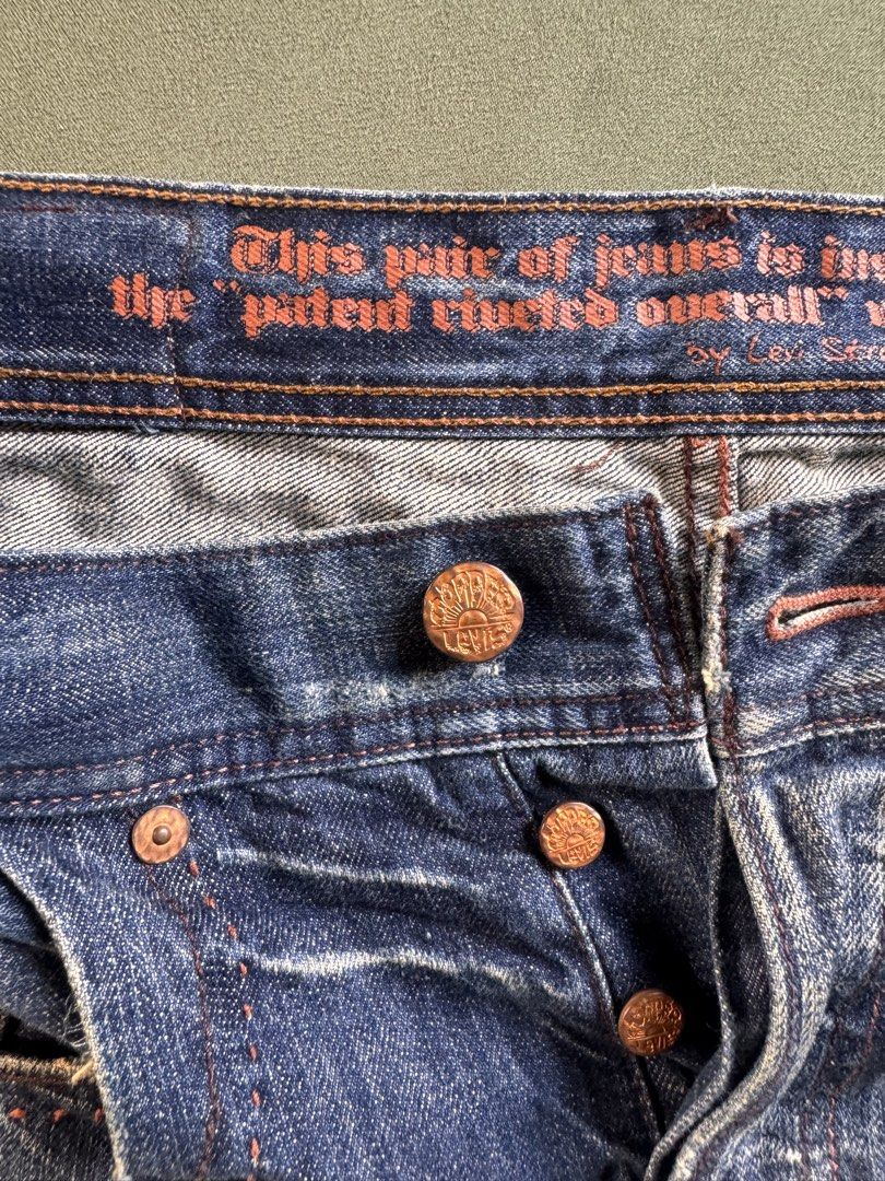 Levi's Distressed Denim Jeans Button Fly Size 32 (Category: Jeans) located in Santa Lucia. Submitted by bryantevesartstudio (Listing ID 1470594095, Image 3). Description: Levi's distressed denim jeans. Button fly closure, copper-tone hardware. Vintage-inspired interior waistband text print. Heavy whiskering and fading wash throughout. Intentional distressing near pockets and hems. Brown leather patch on the back waistband. Classic arcuate stitchi
