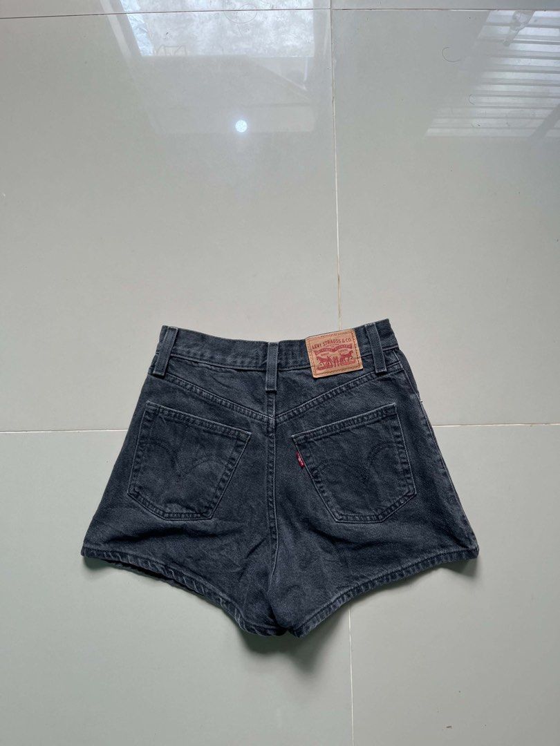 Levi's High-Waisted Denim Shorts Black Washed (Category: Shorts) located in Lapu Lapu. Submitted by trip-thrift (Listing ID 1470642976, Image 1). Description: - Brand: Levi's - Color: Black washed denim - Fit: High waist - Details: Classic button and zip fly, functional back pockets, belt loops - Branding: Iconic leather patch at the back waistband - Condition: Great staple piece for casual, warm-weather outfits.