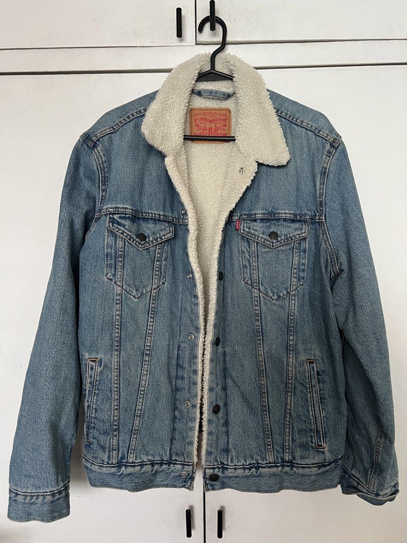Levi's Sherpa Trucker Denim Jacket (Category: Coats, Jackets and Outerwear) located in Quezon City. Submitted by Zandee (Listing ID 1470653124, Image 1). Description: - Brand: Levi's - Style: Denim Trucker Jacket with white sherpa lining & collar - Wash: Classic light wash - Pockets: Front chest flap pockets & side hand pockets - Details: Metal button closures, warm and comfortable fit - Condition: Excellent / Ready to wear.