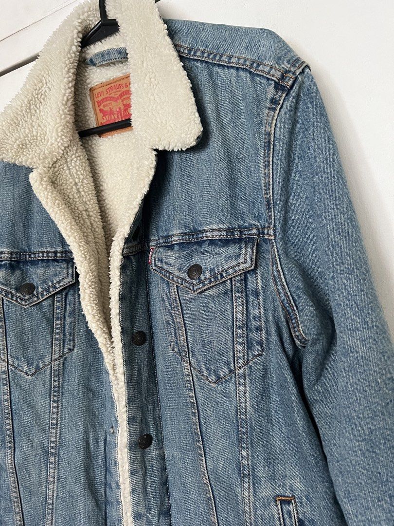 Levi's Sherpa Trucker Denim Jacket (Category: Coats, Jackets and Outerwear) located in Quezon City. Submitted by Zandee (Listing ID 1470653124, Image 3). Description: - Brand: Levi's - Style: Denim Trucker Jacket with white sherpa lining & collar - Wash: Classic light wash - Pockets: Front chest flap pockets & side hand pockets - Details: Metal button closures, warm and comfortable fit - Condition: Excellent / Ready to wear.