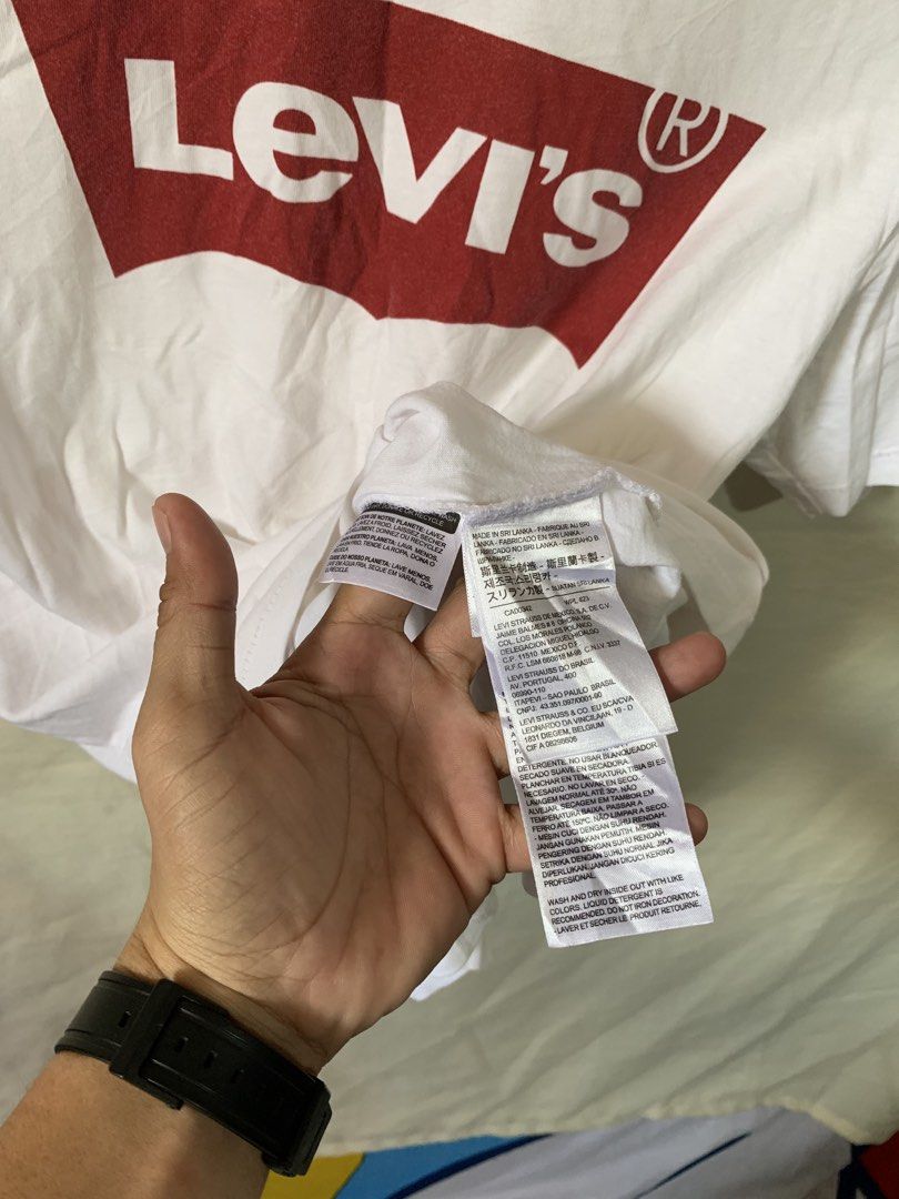Levi's White Graphic T-Shirt (Category: Shirts) located in Davao. Submitted by cheineebau09680 (Listing ID 1470607455, Image 3). Description: - Brand: Levi's - Color: White with iconic red batwing logo - Size: Small (Standard fit) - Material: 100% Cotton - Details: Crew neckline, short sleeves, includes original inside care tags - Origin: Made in Sri Lanka - Condition: Brand new / Excellent pre-loved.